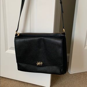 Freshly picked black crossbody diaper bag.